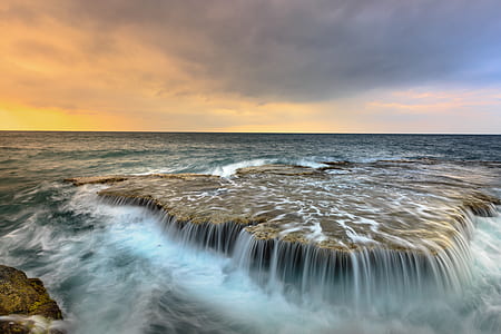 time lapse photo of rock formation near sea thumbnail