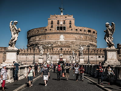 people near round brown concrete building during daytime thumbnail