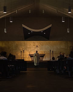 priest standing on altar church thumbnail