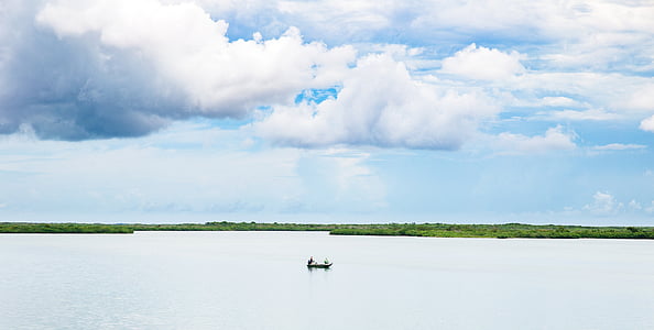 person on-boat in the middle of body of water during daytime thumbnail