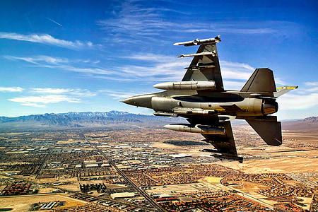 gray jetfighter flying over base thumbnail