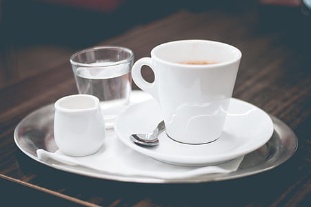 white mug and spoon on saucer thumbnail