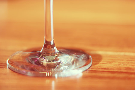 round glass stem on brown wooden table thumbnail