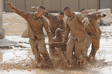 group of mens in brown mud during daytime thumbnail