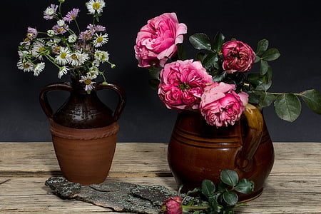 pink roses in brown vase on table thumbnail
