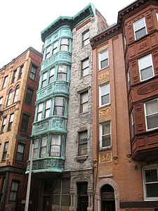 Teal and Brown Concrete Buildings Under Cloudy Sky thumbnail