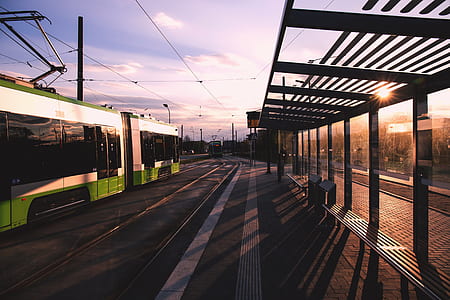 Green and White Train Near Train Terminal during Daytime thumbnail
