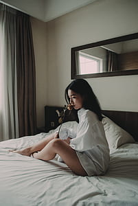 woman sitting on bed thumbnail