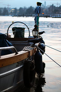 shallow focus photo of gray steel boat with black buoys thumbnail