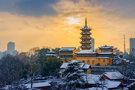 snow covered temple and houses during day thumbnail