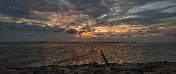 calm body of water during golden hour thumbnail