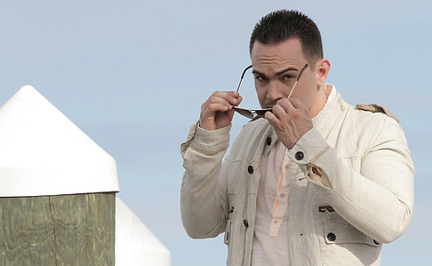 man holding sunglasses thumbnail