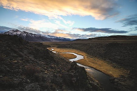 aerial photo of river beside rocky mountain and valley at daytime thumbnail