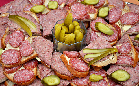 sliced pickled cucumbers, sliced sausages,and breads thumbnail