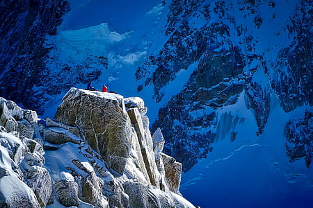 person in red shirt on snowy mountain during daytime thumbnail