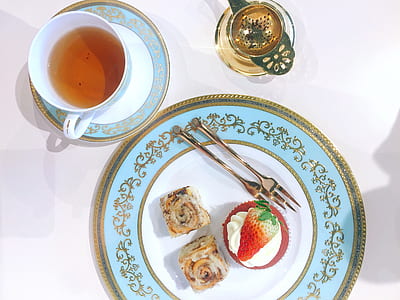 teacup filled with tea beside saucer thumbnail