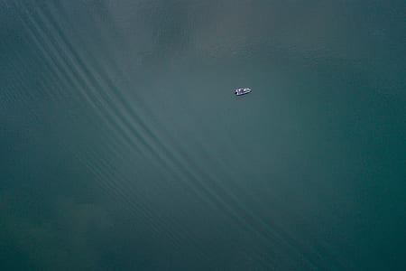 bird's eye view of boat on body of water thumbnail