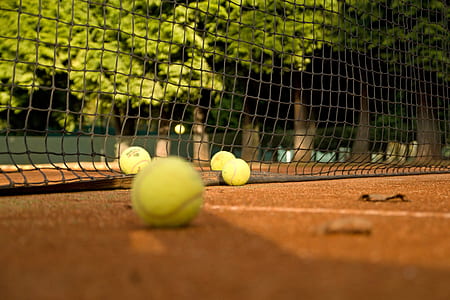 four tennis balls on court thumbnail