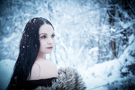 woman wearing black top sitting on white snow covered ground thumbnail