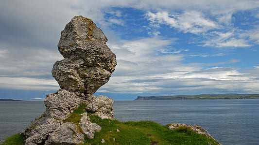 rock formation in front of calm body of w ater thumbnail