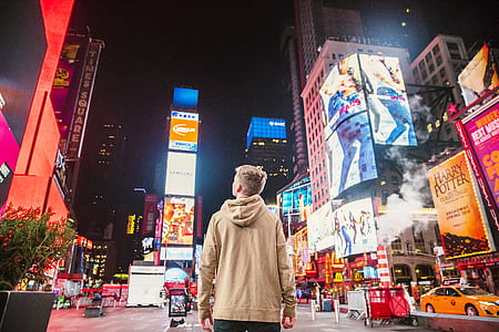 man standing in New York Times Square thumbnail