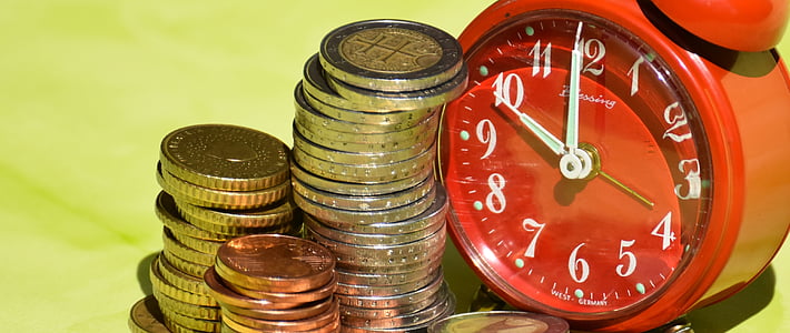 assorted coins beside red bell alarm clock thumbnail