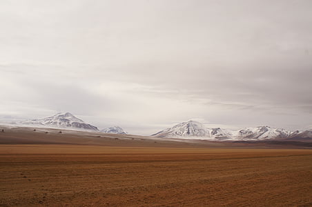 snow-covered mountain under white clouds at daytime thumbnail