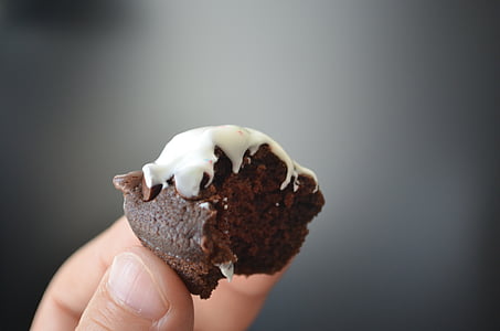 person holding brown cupcake thumbnail