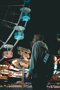 man smoking cigarette near ferry's wheel thumbnail