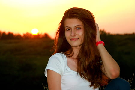 woman wearing white scoop-neck shirt during sunset thumbnail