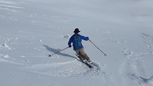 man skiing on snow during daytime thumbnail