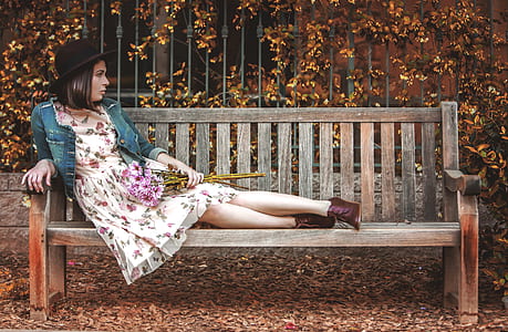 selective focus photography of woman reclining on bench thumbnail