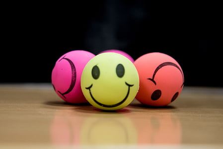 selective focus photography of four smiley balls thumbnail