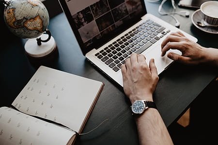 Male working with a laptop and a cup of coffee thumbnail
