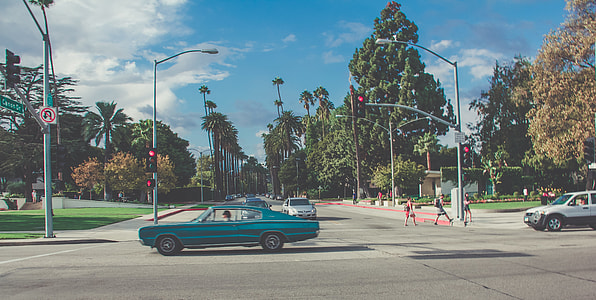 people walking on pedestrian lane near cars at daytime thumbnail