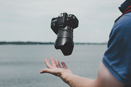 person wearing blue shirt near body of water under cloudy sky during daytime thumbnail