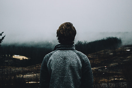 person wearing grey jacket while looking on sky thumbnail