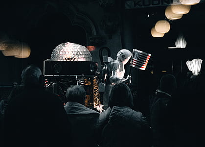 people watching astronaut holding flag of USA thumbnail