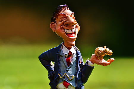man holding figurine toy thumbnail