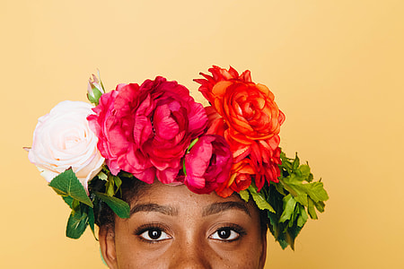 assorted-color petaled flowers on person's head thumbnail