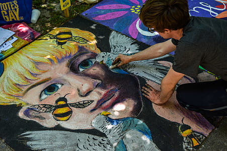 Man Painting Face of Human and Bird thumbnail