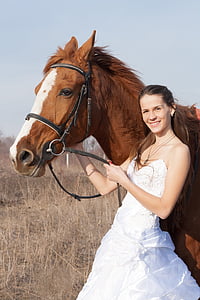 woman standing beside horse thumbnail