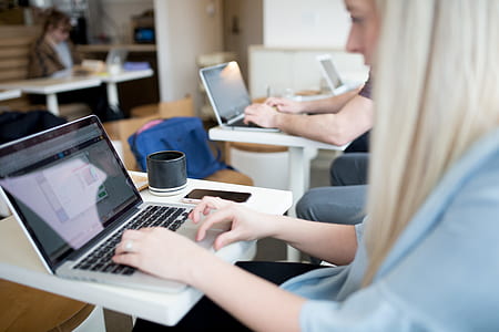 woman in blue top holding laptop thumbnail