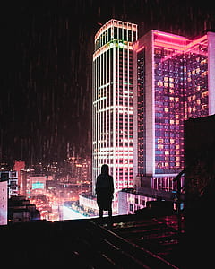 person standing on roof across buildings thumbnail