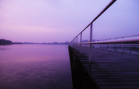 wooden dock on body of water during daytime thumbnail