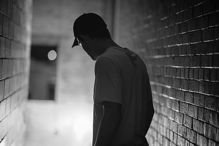 grayscale photo of man in white crew-neck T-shirt thumbnail