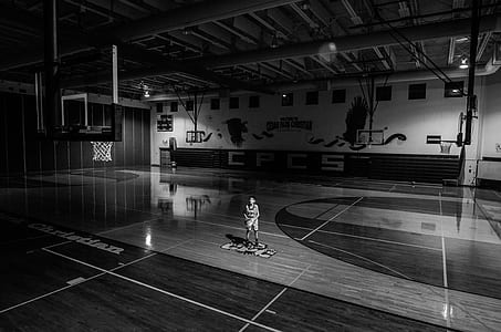 man holding basketball on basketball court thumbnail