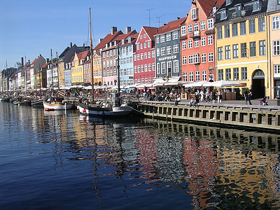 sail boats docks beside houses thumbnail