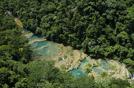 aerial photography of flowing waterfalls surrounded by trees thumbnail