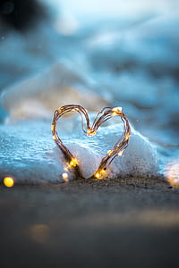 brown metal wire forming heart shape while covered in white bubbles thumbnail
